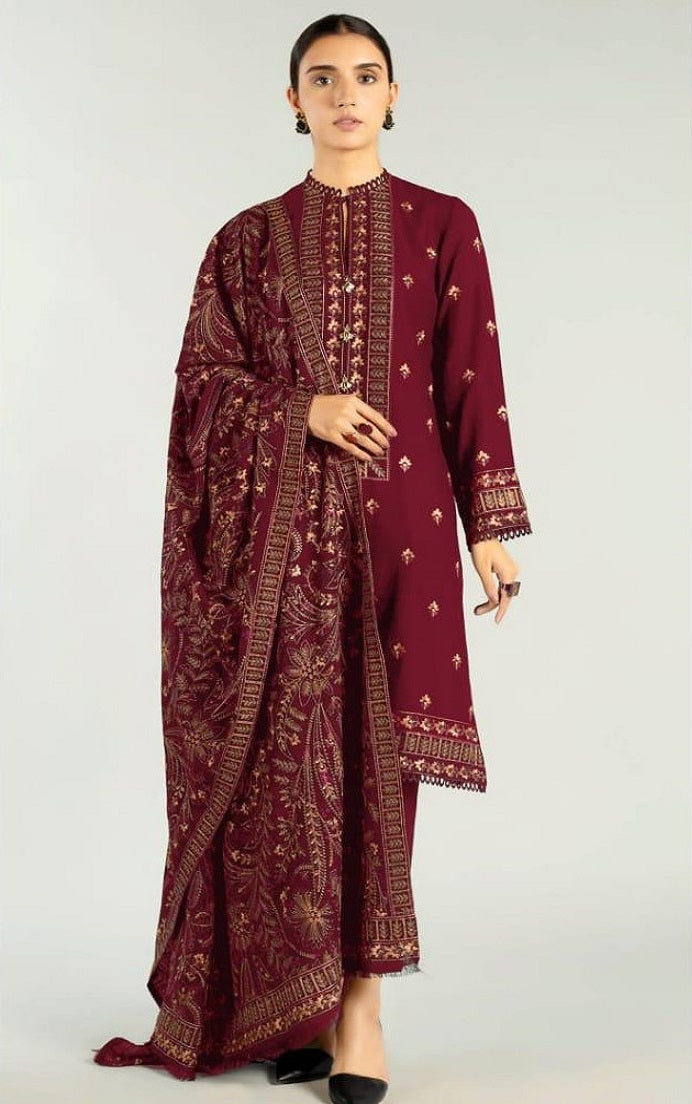 Maroon embroidered traditional outfit on a white background